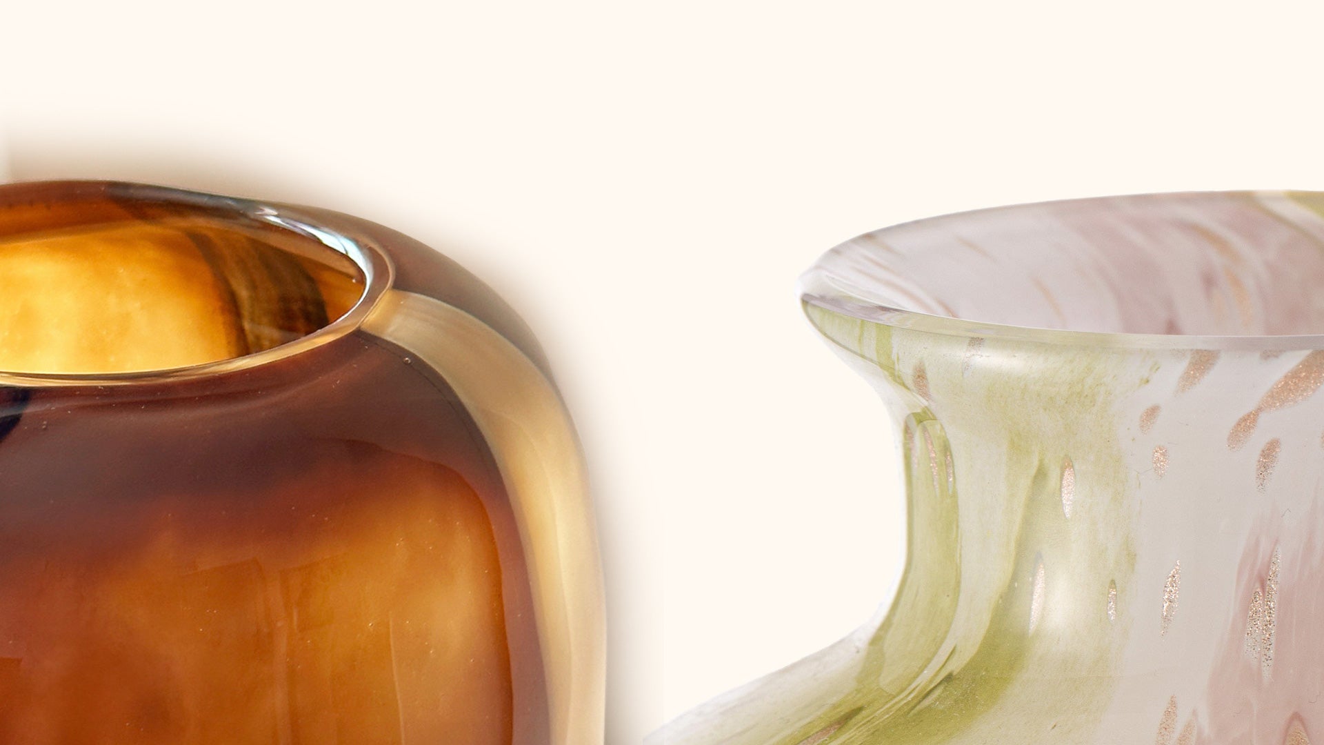 Two glass vases with one in gold and the other in a multicolored pattern on a white background