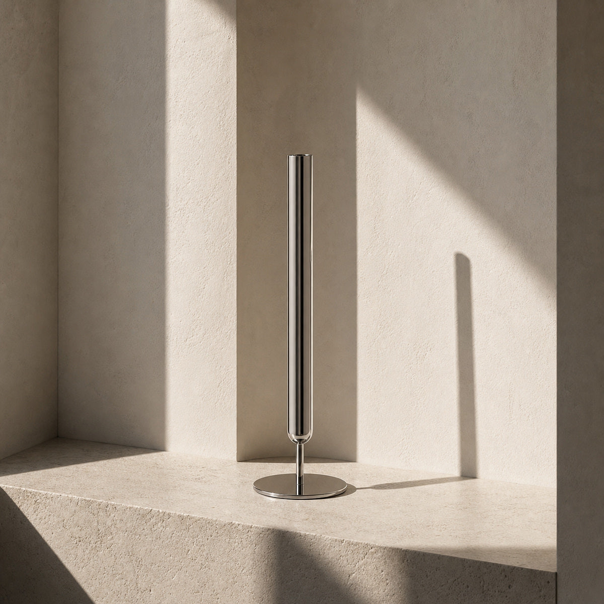 Contemporary silver stem vase, the Lumina Vase Axis, showcasing its pure geometric design without botanicals. The architectural piece is set in a serene, minimalist niche with high-contrast natural lighting and organic stone textures.