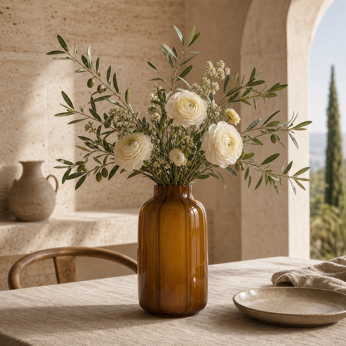 Brown modern tranlucent glass vase with white flowers on a limestone table in a warm-toned italian style room.